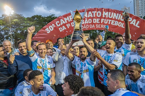 Tudo Nosso leva a taça de Campeão da 1ª Divisão de Futebol